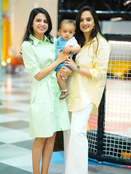 A lovely photo of two moms with a baby, enjoying the bright and cheerful atmosphere of our play zone.