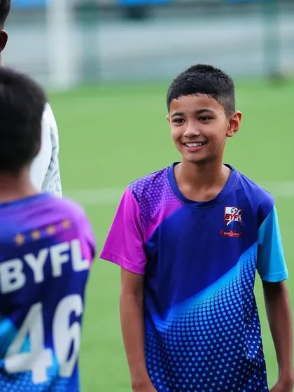 A smiling player during a U13 training session. We believe in creating a positive and enjoyable learning environment.