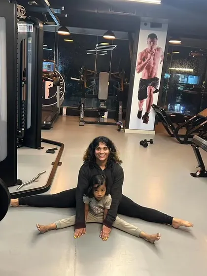 Fitness is for all ages. Here I am working on flexibility with a little one, showing that it's never too early to build healthy habits.
