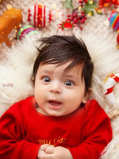 A look of pure wonder. This close-up from a 'My First Christmas' session captures the magic of the holidays through a baby's eyes.