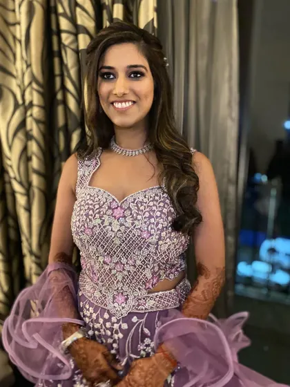 A beautiful smile from this Sangeet bride. Her purple eyeshadow and glowing skin make for a stunning party look.