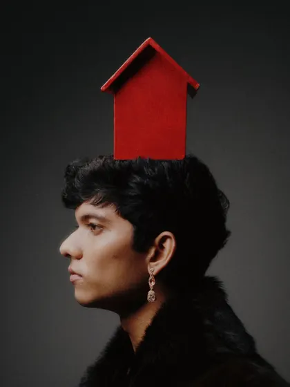 A surreal and conceptual portrait from the same series, featuring a small red house placed on the model's head. This demonstrates my strength in concept development and creating thought-provoking visuals.