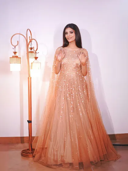 A full-length view of the golden gown, showing its beautiful flow and sparkle.