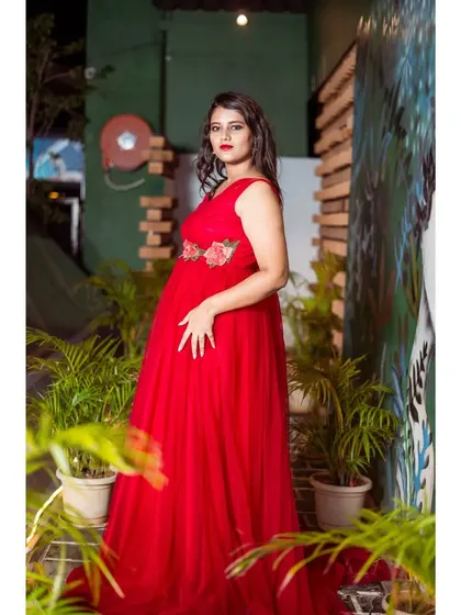 A side view of the client in the red tulle gown.