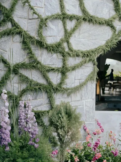 Another angle of the custom greenery installation. Every curve and line was intentionally placed by our team to create a sense of movement and natural elegance on the building's facade.
