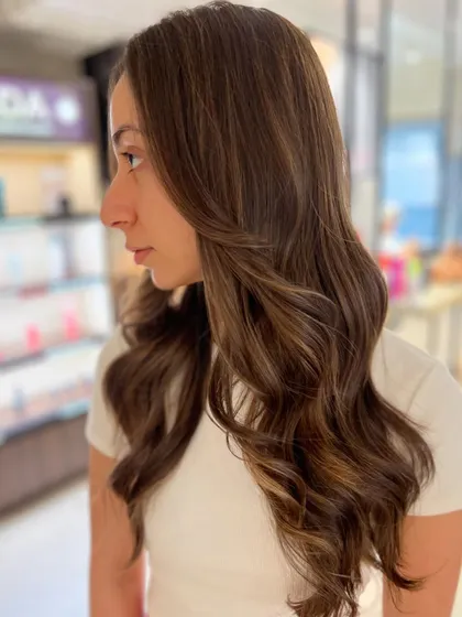 A lovely two-tone caramel highlight blend created without bleach. This technique keeps the hair healthy while adding beautiful, warm dimension.