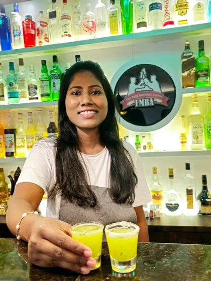 Two bright yellow kiwi shots with a salted rim, ready to be enjoyed.