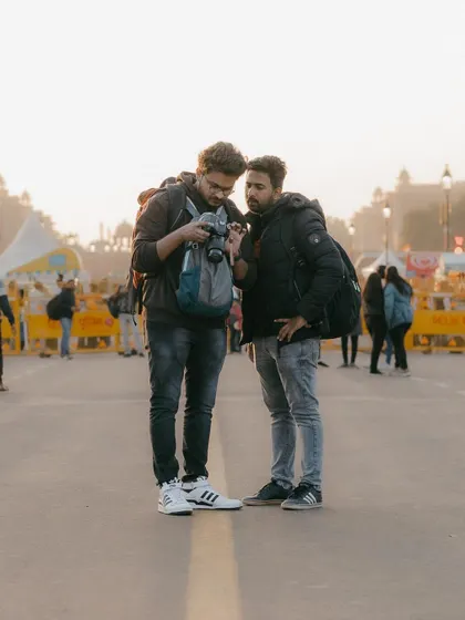 A lot of what I teach happens right on the street. Here, I'm reviewing shots on my camera with a friend at India Gate. Our sessions are collaborative, focusing on hands on learning and immediate feedback to improve your photography skills in real time.