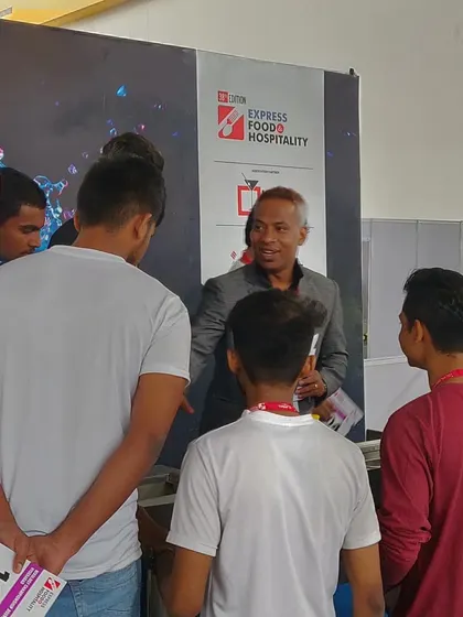 Mentoring the next generation. I'm seen here talking to a group of young, aspiring bartenders at a mixology competition, sharing advice and encouragement.