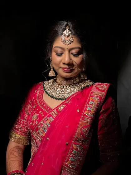 A serene portrait with dramatic, focused lighting. This shot emphasizes the flawless eye makeup and the smooth, radiant finish on the skin, showing how the look holds up under different lighting conditions.
