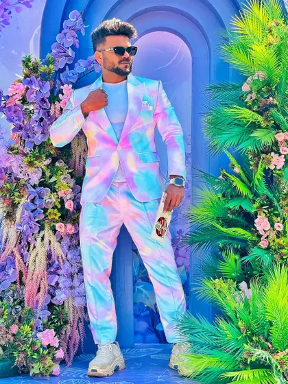 Posing against a floral backdrop that complements my unique suit.
