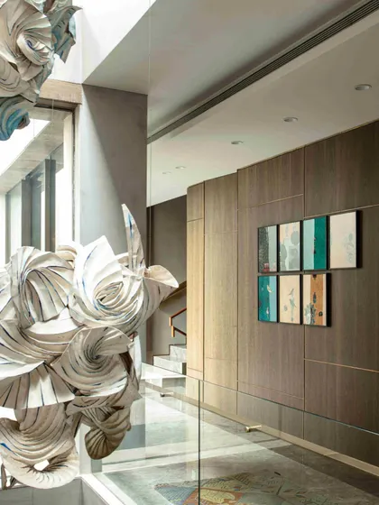 A detailed shot of the 'Radha Krishna Raas Leela' installation, focusing on the texture and form created by the folded, spray-painted fabric. The artwork is not just seen but experienced as it interacts with light and shadow.
