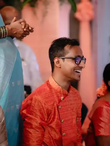 A candid shot of the groom smiling during his engagement ceremony. We make sure to capture the joy of both the bride and the groom.