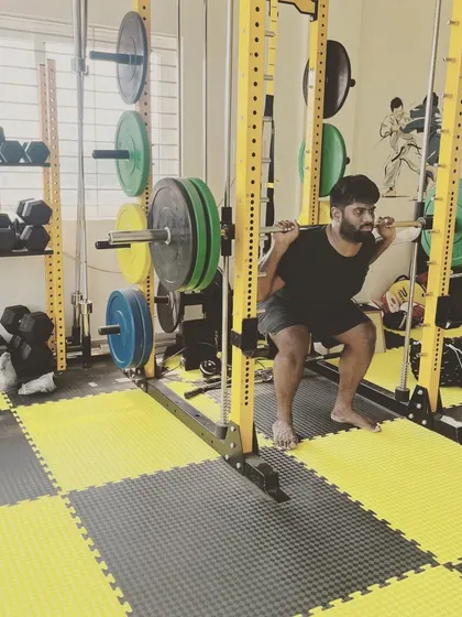 Building a strong foundation is key. Here, a member performs a heavy barbell back squat in our fully equipped strength area, focusing on proper form to build serious lower body power.