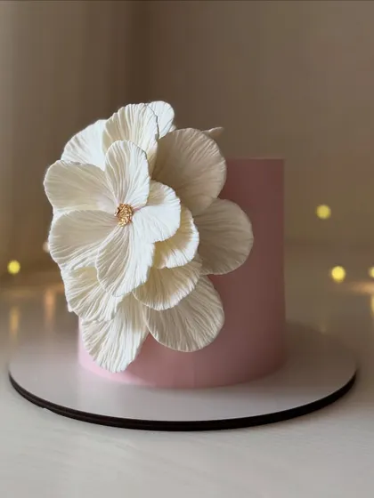 Another view of the minimalist cake with a large, textured wafer paper flower, showing how a single element can be a powerful statement.