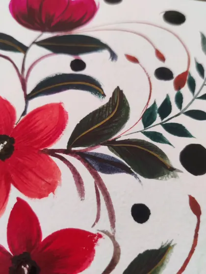 A macro shot showing the clean lines and layered colors in the gouache floral painting.