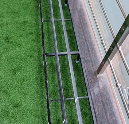 A close-up of our metal stands placed on artificial grass. The stands have protective bushes on their feet to prevent any damage to the flooring.