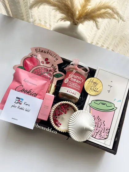 A perfect Rakhi hamper for a sister who loves to be pampered. It includes a planner, gourmet coffee, a scented candle, perfume, cookies, and a face mask.