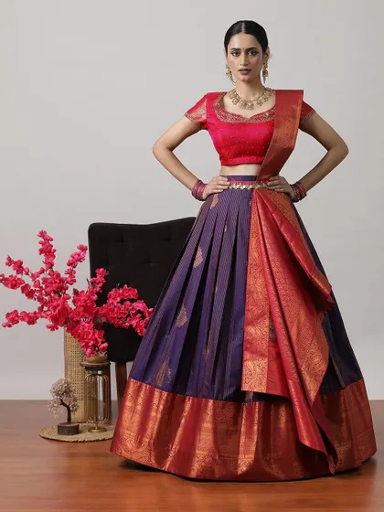 A deep purple and red half-saree lehenga, a bold and beautiful choice for any celebration.