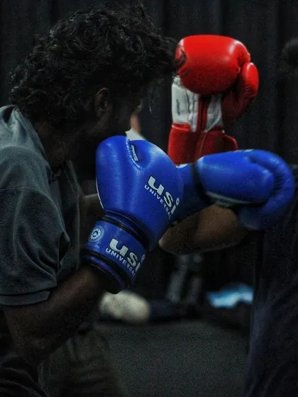 An intense exchange during sparring. Both boxers are trading punches, testing each other's defense and conditioning.