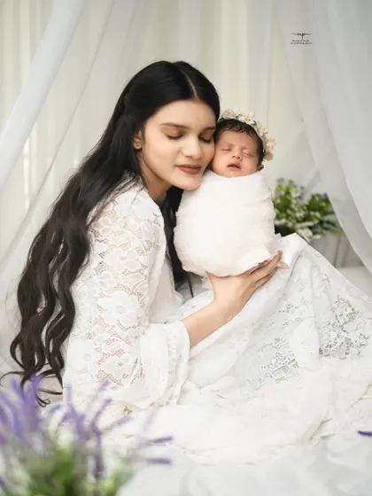 The pure bliss of a mother holding her baby close. The delicate lace and soft light add to the angelic feel of this portrait.