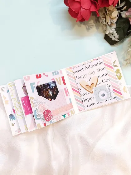 This page from a mini album features a cute polaroid camera embellishment, perfect for a photo-filled gift.