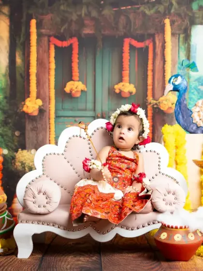 Looking up with curiosity, this little Gopi is the star of the show. The vibrant colors and traditional elements make these portraits stand out.