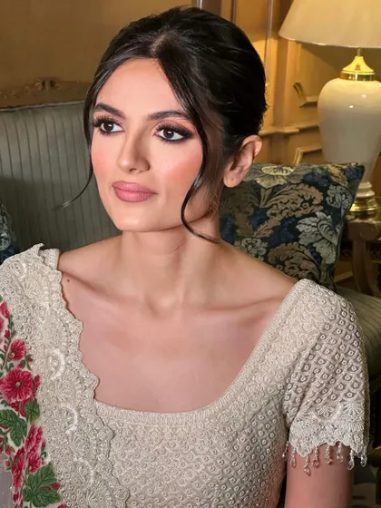 A soft, messy updo with loose tendrils for a romantic and modern feel.