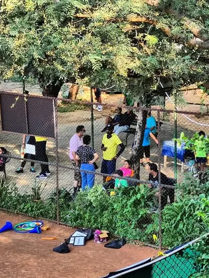 A view of the academy during a busy tournament weekend, with players, parents, and coaches gathered around the clay courts.
