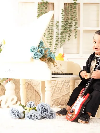 Ready to rock his first year! A fun shot with a mini guitar to celebrate turning one.