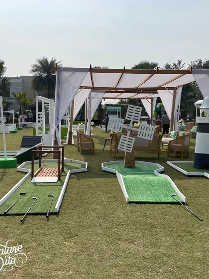 A mini-golf course I set up for a sports-themed party, complete with fun obstacles like a windmill and a lighthouse.