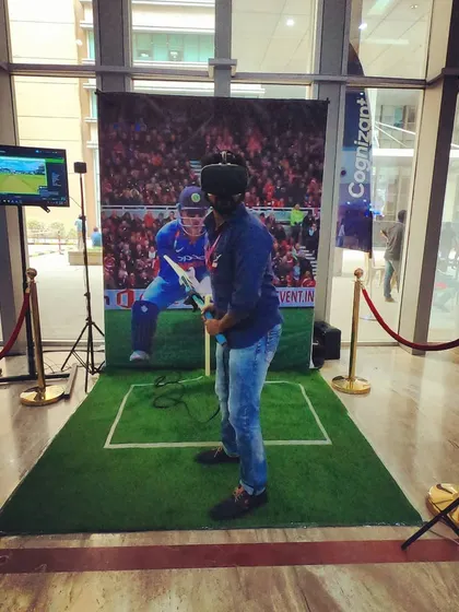 A full view of our VR cricket installation at a corporate event for Cognizant. The compact footprint, including the player area, screen, and sensor stands, is designed to fit seamlessly into office lobbies, conference halls, and event venues.