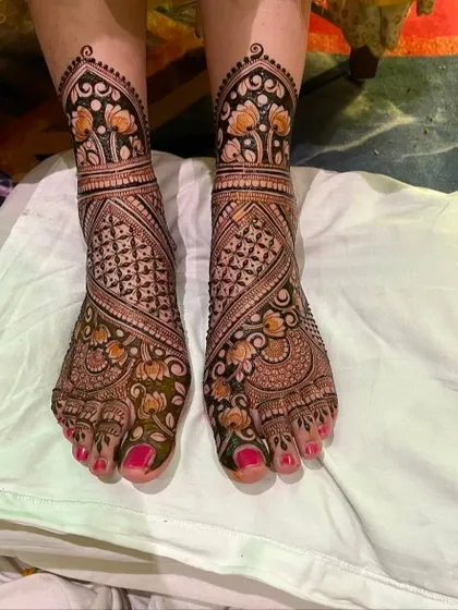 This foot design uses negative space to highlight the beautiful floral and paisley patterns. The dark stain ensures the design will look stunning on your wedding day.