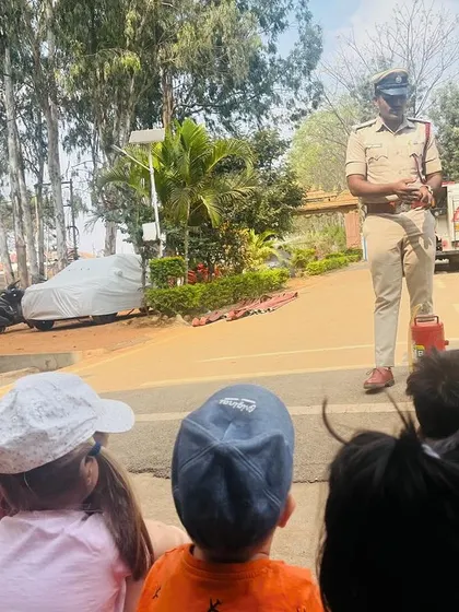 A firefighter explains how to use a fire extinguisher, teaching the children valuable safety information.