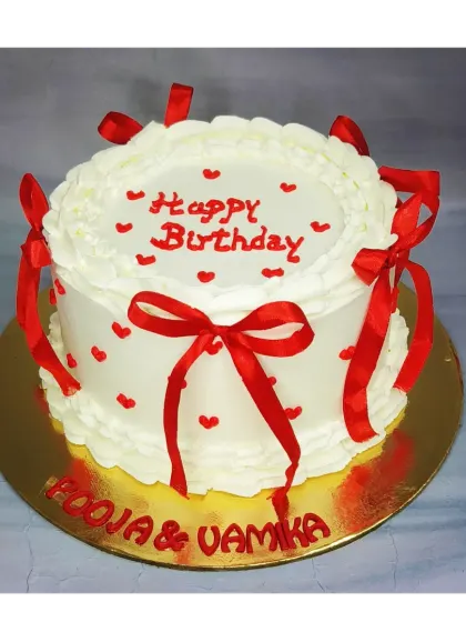 A classic vintage-style cake with red ribbon bows. This mixed fruit cake is perfect for a shared birthday celebration, offering a simple and timeless design.