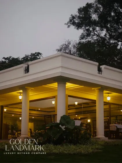 As the sun sets, the Golden Landmark stands as a beacon of refined architecture. The classical columns and warm lighting create an atmosphere of serene elegance.