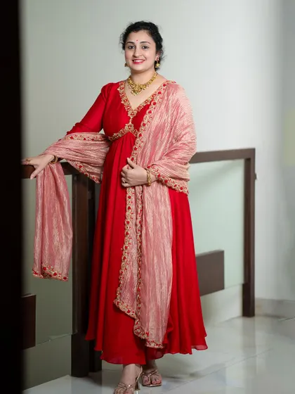 A full view of the red Anarkali, perfect for a festive occasion or a wedding event.