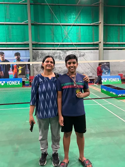 A proud moment for Shantvik and his mother after his bronze medal win at the state championship. Family support is vital for a young athlete's success.