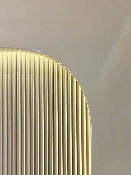 An abstract close-up of a fluted glass panel used in one of our projects. This detail highlights our use of texture and light to add depth and sophistication to our interior designs.