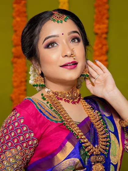 A bright and beautiful portrait from a photoshoot, showcasing a classic South Indian look with a modern touch.