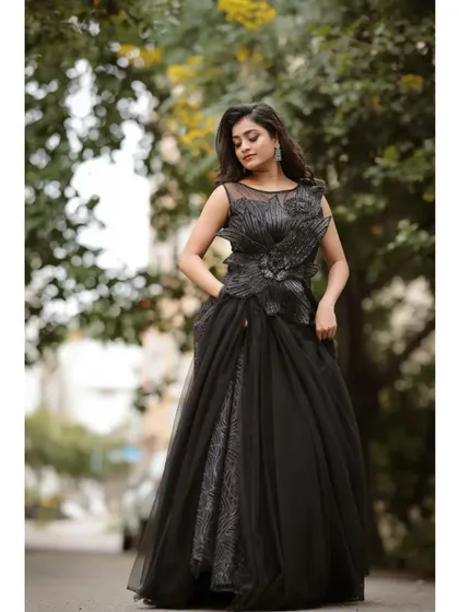 This full-length shot captures the grandeur of the black evening gown, a perfect choice for a reception or a dramatic pre-wedding photoshoot.