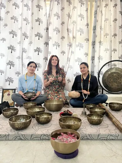 A group of students celebrates their graduation from the sound healing course, ready to share their knowledge.