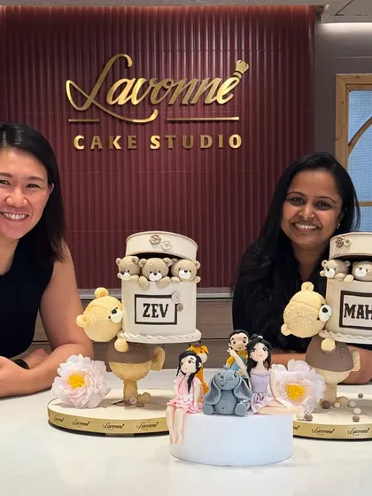 I’m so blessed to create cakes that celebrate special moments. Here I am with a happy client and her custom cakes, including fondant family figurines and teddy bears. Each cake tells a unique story.