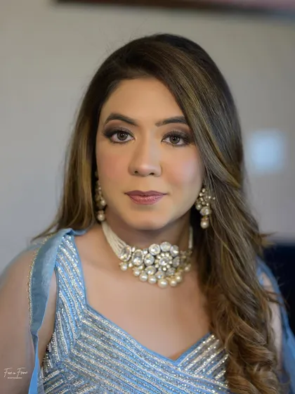 A closer look at this perfectly coordinated style. The makeup is kept soft and radiant to let the sparkling outfit and beautiful choker necklace shine.