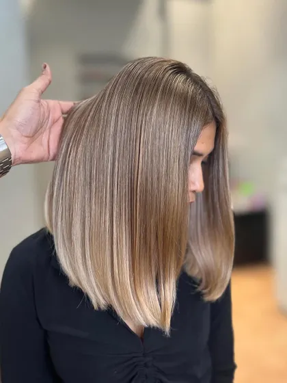 A close-up of the Airtouch Balayage result. The hair is straight here to show the seamless blend and the healthy condition of the hair.