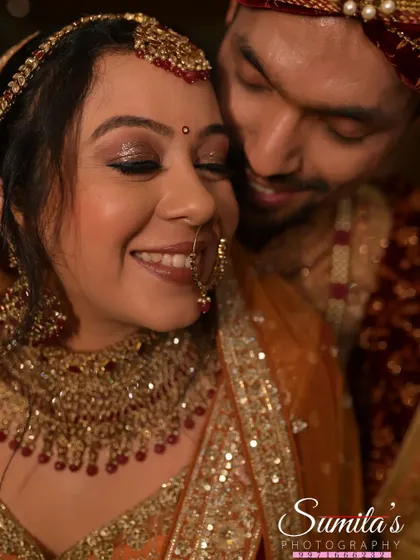 A close-up shot filled with warmth and affection. The groom's gentle lean and the bride's blissful smile make this a heartwarming wedding portrait.