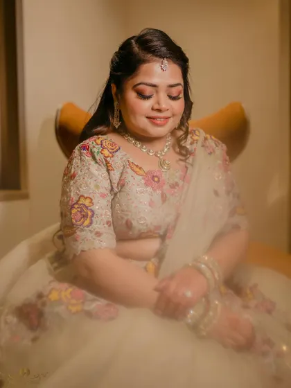 A soft and serene portrait of the bride with her eyes closed, a gentle smile on her face. This shot captures a moment of quiet happiness.