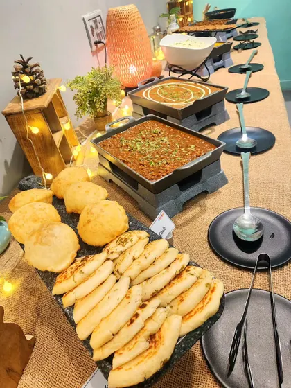 A delicious buffet spread featuring classic Indian comfort food like chole with bhature and naan. I make sure there's always hearty and yummy food for the parents too.