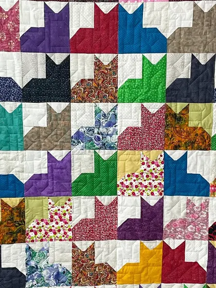 A close-up of a "Cat City" quilt, showing the simple, effective quilting.