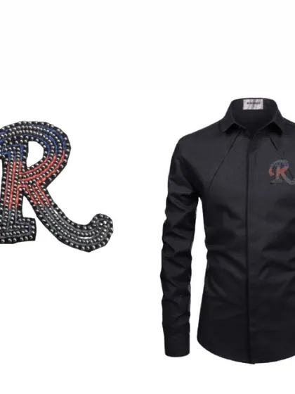 An example of our handcrafted initial patch on a plain black shirt. The 'R' patch, made with colorful studs, instantly transforms the simple shirt into a personalized statement piece.